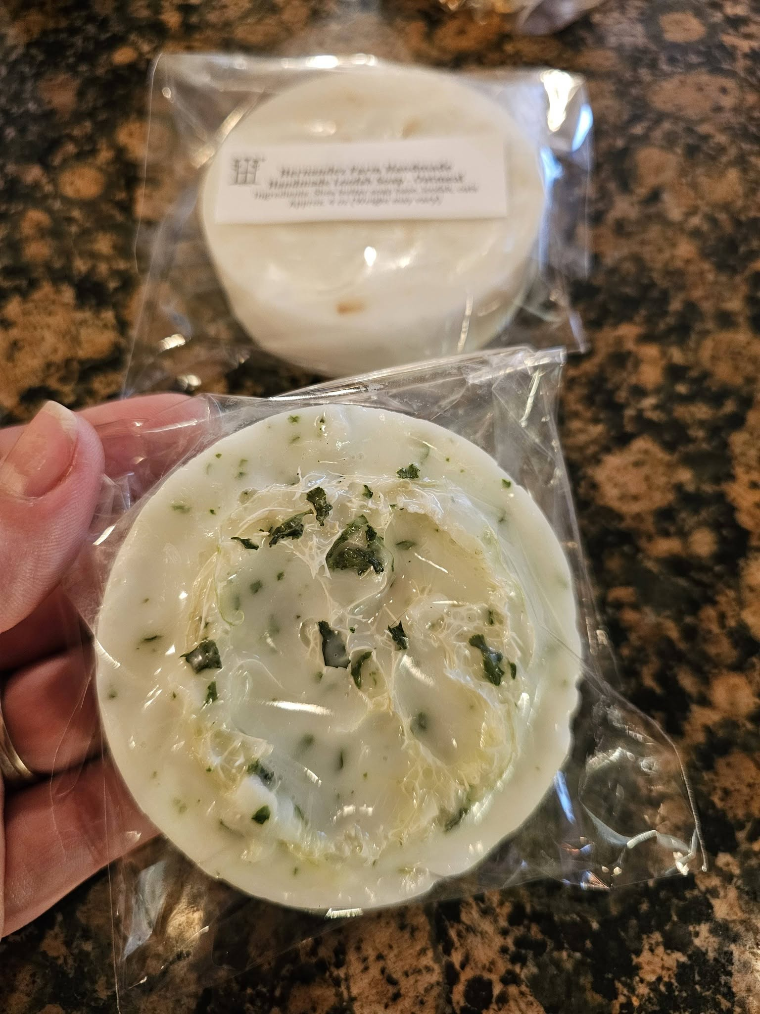 Mint loofah soap with mint leaves throughout the bar